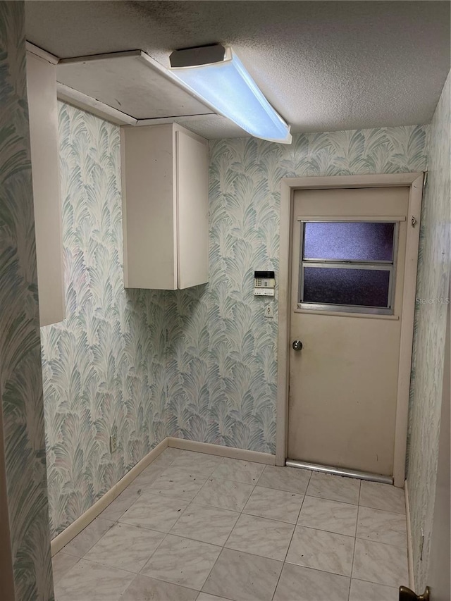 laundry area with a textured ceiling