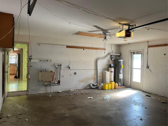 garage featuring sink, a garage door opener, ceiling fan, and water heater