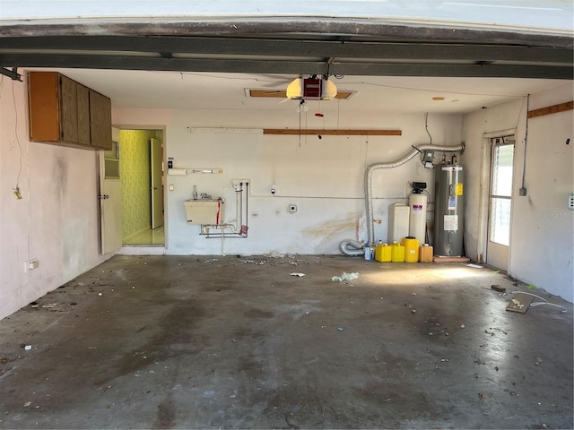 garage featuring electric water heater, a garage door opener, and sink