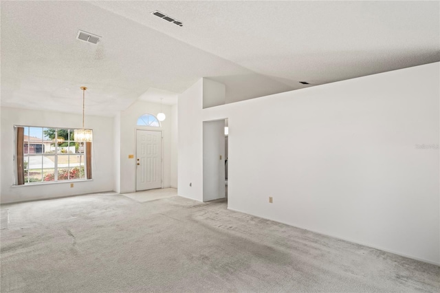 spare room featuring high vaulted ceiling, a textured ceiling, and light carpet