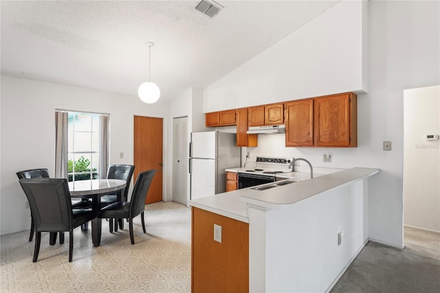 kitchen featuring sink, decorative light fixtures, white appliances, kitchen peninsula, and high vaulted ceiling