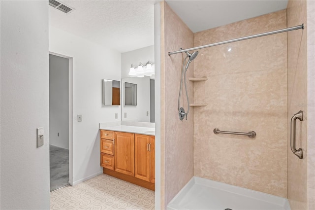 bathroom featuring a shower and vanity