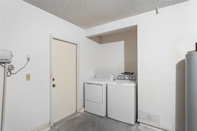 washroom featuring independent washer and dryer and a textured ceiling