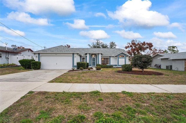 ranch-style house with central AC unit, a garage, and a front lawn