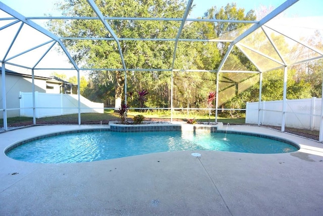 view of pool with a lanai, pool water feature, and a patio area