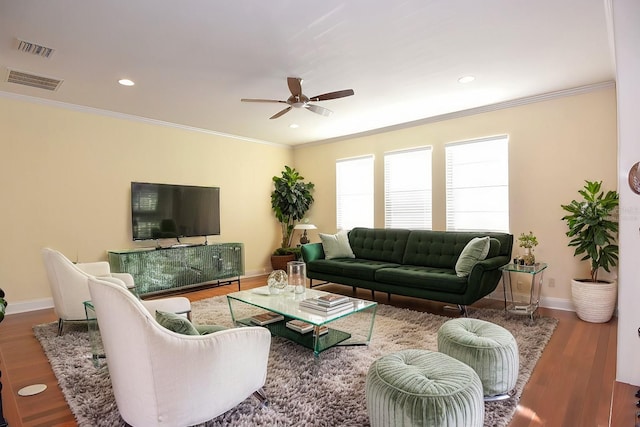 living room featuring hardwood / wood-style floors, ceiling fan, and ornamental molding