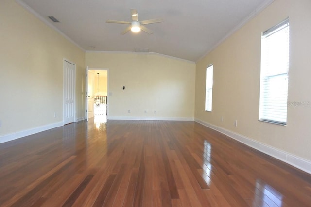 spare room featuring ceiling fan, dark wood-type flooring, and crown molding