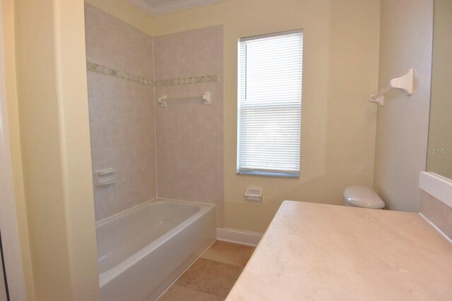 bathroom with vanity, tile patterned flooring, tiled shower / bath combo, and crown molding