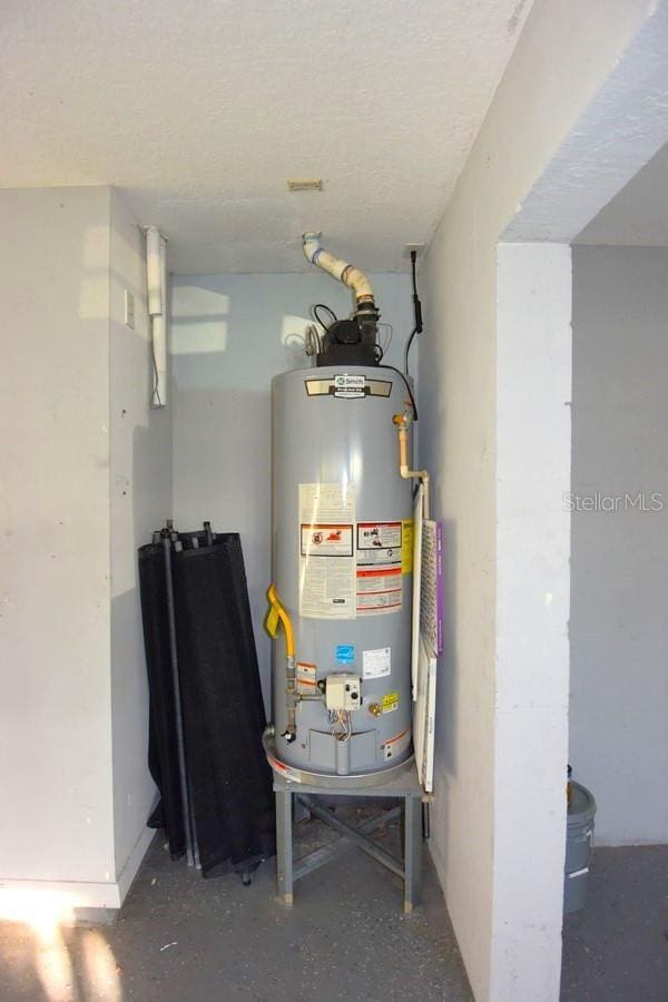 utility room featuring gas water heater