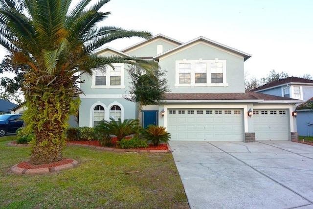 view of front of home with a front yard and a garage