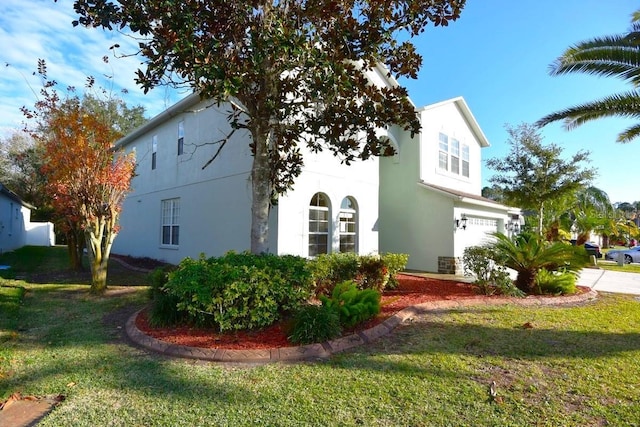 view of property exterior featuring a yard and a garage