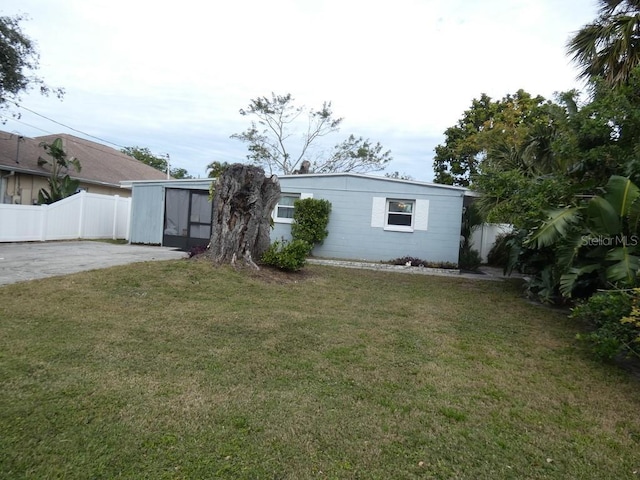 rear view of property with a yard