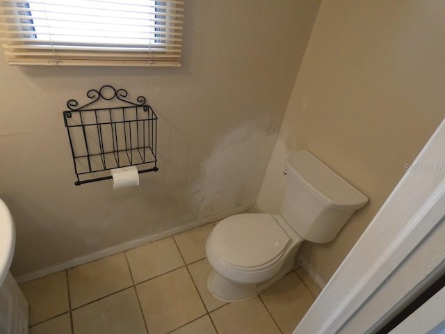 bathroom with tile patterned flooring and toilet