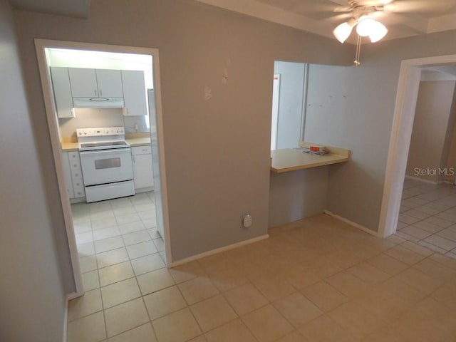 kitchen featuring white cabinets, ceiling fan, light tile patterned floors, and white electric range oven