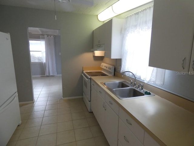 kitchen with white appliances, white cabinetry, sink, and light tile patterned floors