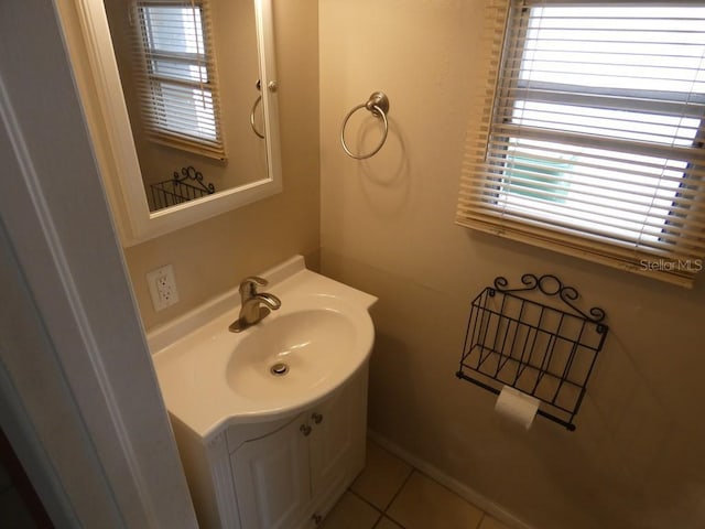 bathroom featuring tile patterned flooring, a wealth of natural light, and vanity