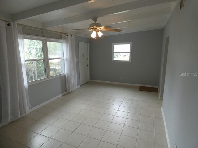 tiled empty room with beamed ceiling, ceiling fan, and plenty of natural light