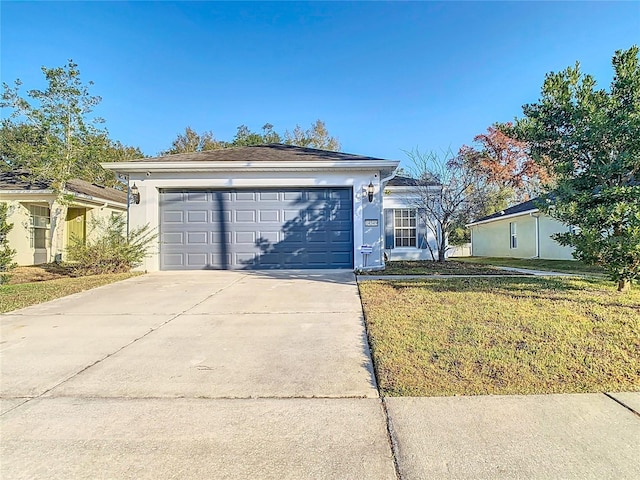 single story home with a front yard and a garage