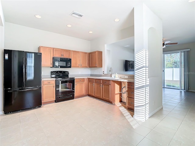 kitchen with sink, light tile patterned floors, ceiling fan, and black appliances