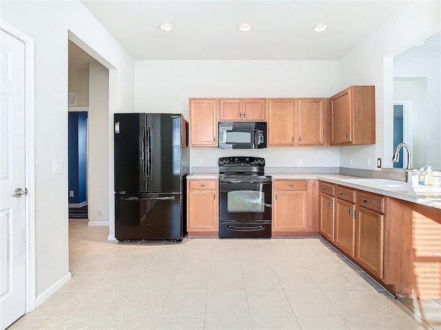 kitchen with light tile patterned flooring, black appliances, and sink