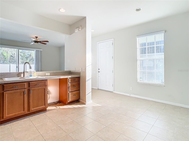 kitchen featuring sink, ceiling fan, and light tile patterned floors