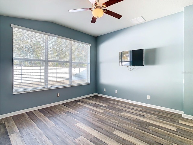 empty room with ceiling fan, hardwood / wood-style floors, and lofted ceiling