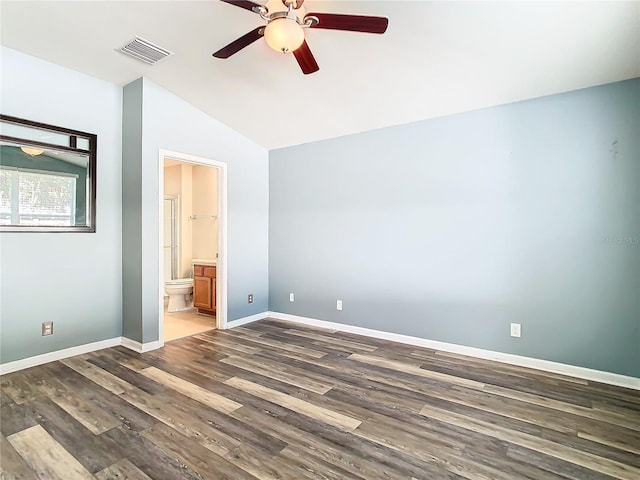 unfurnished bedroom with dark hardwood / wood-style flooring, ensuite bath, ceiling fan, and vaulted ceiling