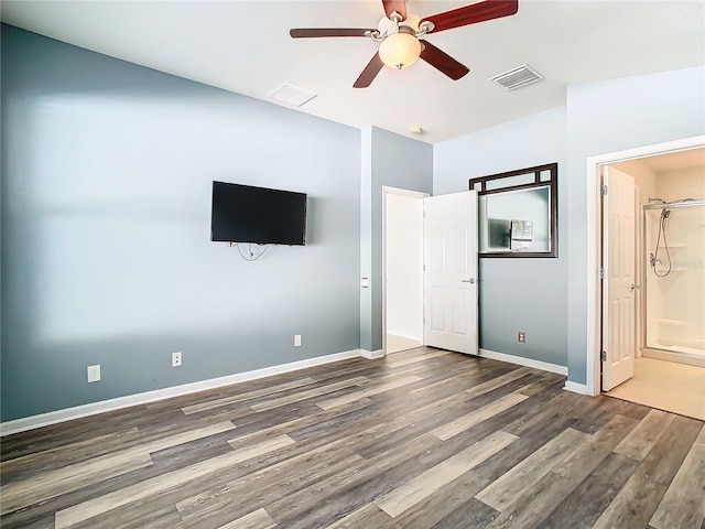 unfurnished bedroom with ensuite bathroom, ceiling fan, and dark hardwood / wood-style flooring