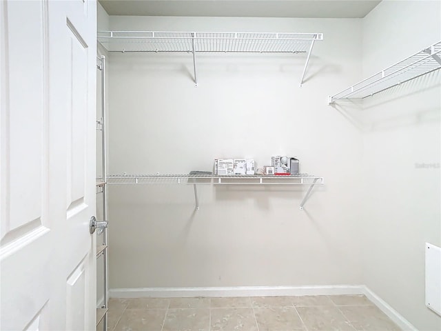 spacious closet with light tile patterned floors