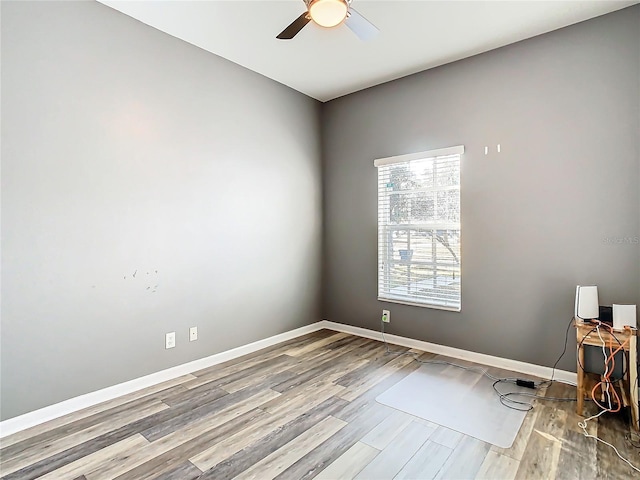 empty room with ceiling fan and hardwood / wood-style flooring