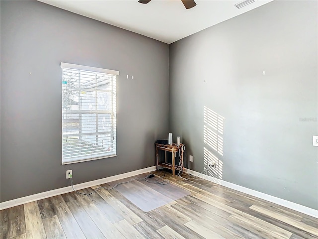 empty room featuring ceiling fan and hardwood / wood-style flooring