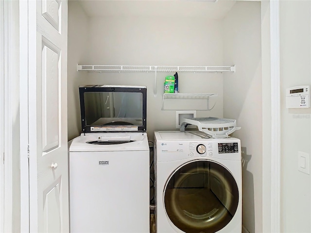 clothes washing area with independent washer and dryer