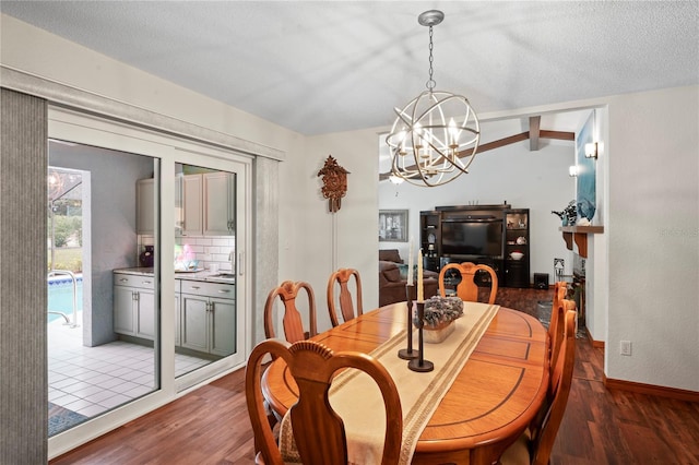 dining area featuring lofted ceiling with beams, dark hardwood / wood-style floors, an inviting chandelier, and a textured ceiling