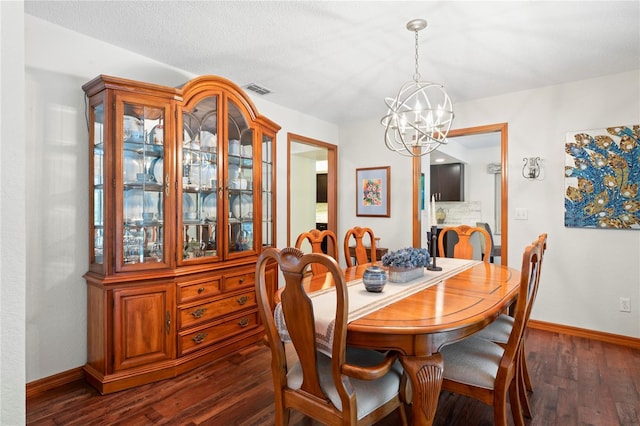 dining area featuring dark wood-type flooring and a chandelier