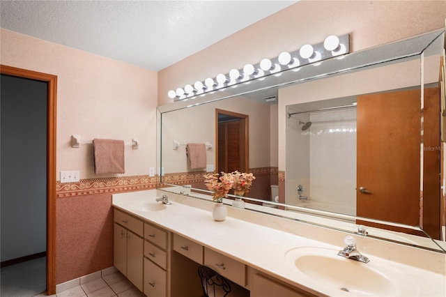 full bathroom featuring a textured ceiling, tile patterned flooring, vanity, shower / washtub combination, and toilet