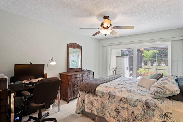 bedroom featuring ceiling fan, access to exterior, light colored carpet, and a textured ceiling