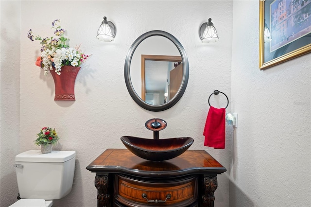 bathroom with toilet and vanity