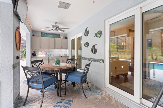 interior space with ceiling fan and sink