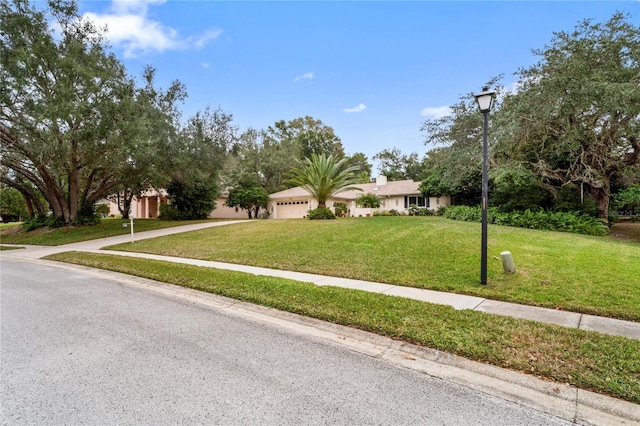 view of front of home featuring a front lawn and a garage