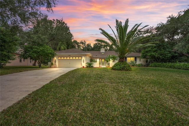 view of front facade with a lawn and a garage