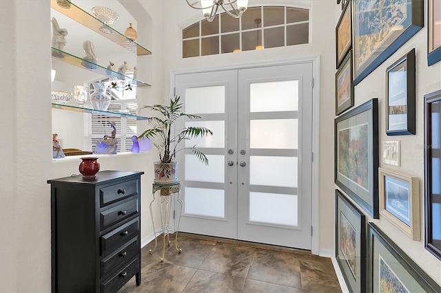 foyer entrance with french doors and a chandelier