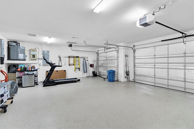 garage with a garage door opener and visible vents