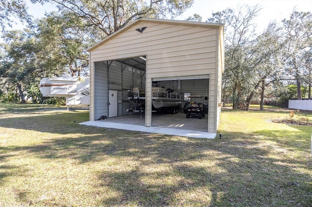 view of pole building featuring a lawn and driveway