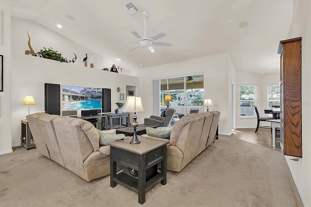 living room with baseboards, visible vents, ceiling fan, vaulted ceiling, and light colored carpet