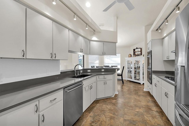 kitchen featuring dark countertops, visible vents, white cabinets, stainless steel appliances, and a sink