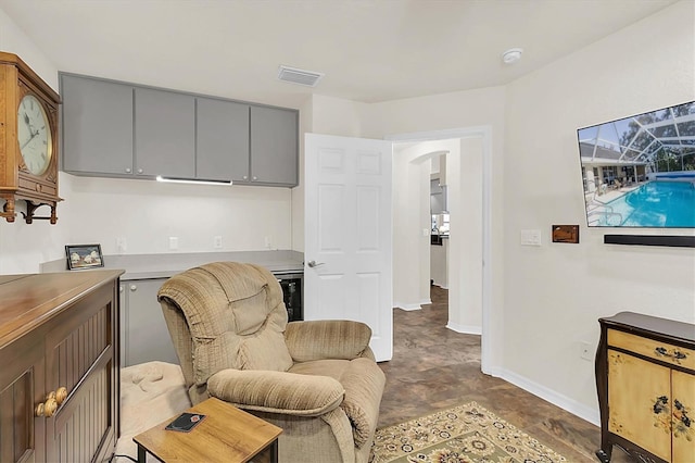 sitting room featuring wine cooler, visible vents, and baseboards