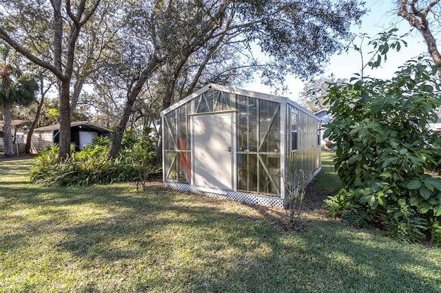 view of greenhouse featuring a yard