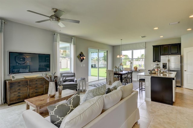 tiled living room featuring ceiling fan