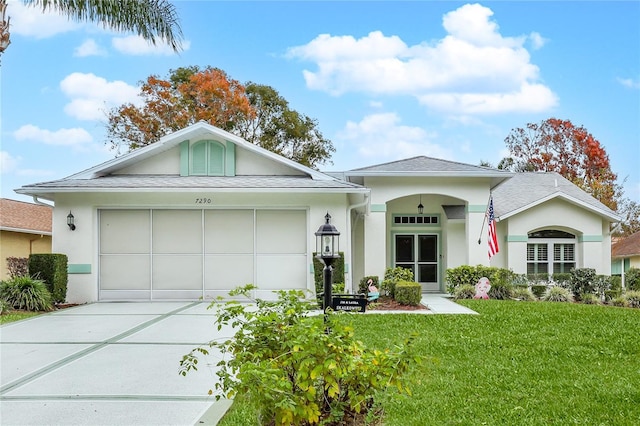 ranch-style home with a garage and a front yard