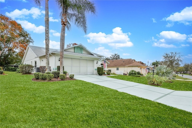 view of front of home with a front yard and a garage